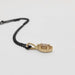 Side view of marquise champagne diamond pendant in 14kt yellow gold with beaded halo