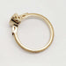 Side profile of milgrain-detailed yellow gold engagement ring showing openwork setting
