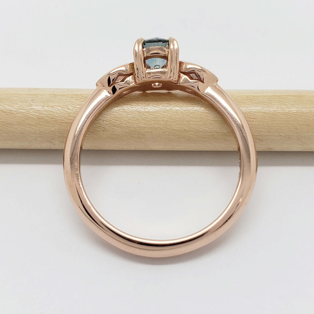 Side view of rose gold Montana sapphire engagement ring showing setting details