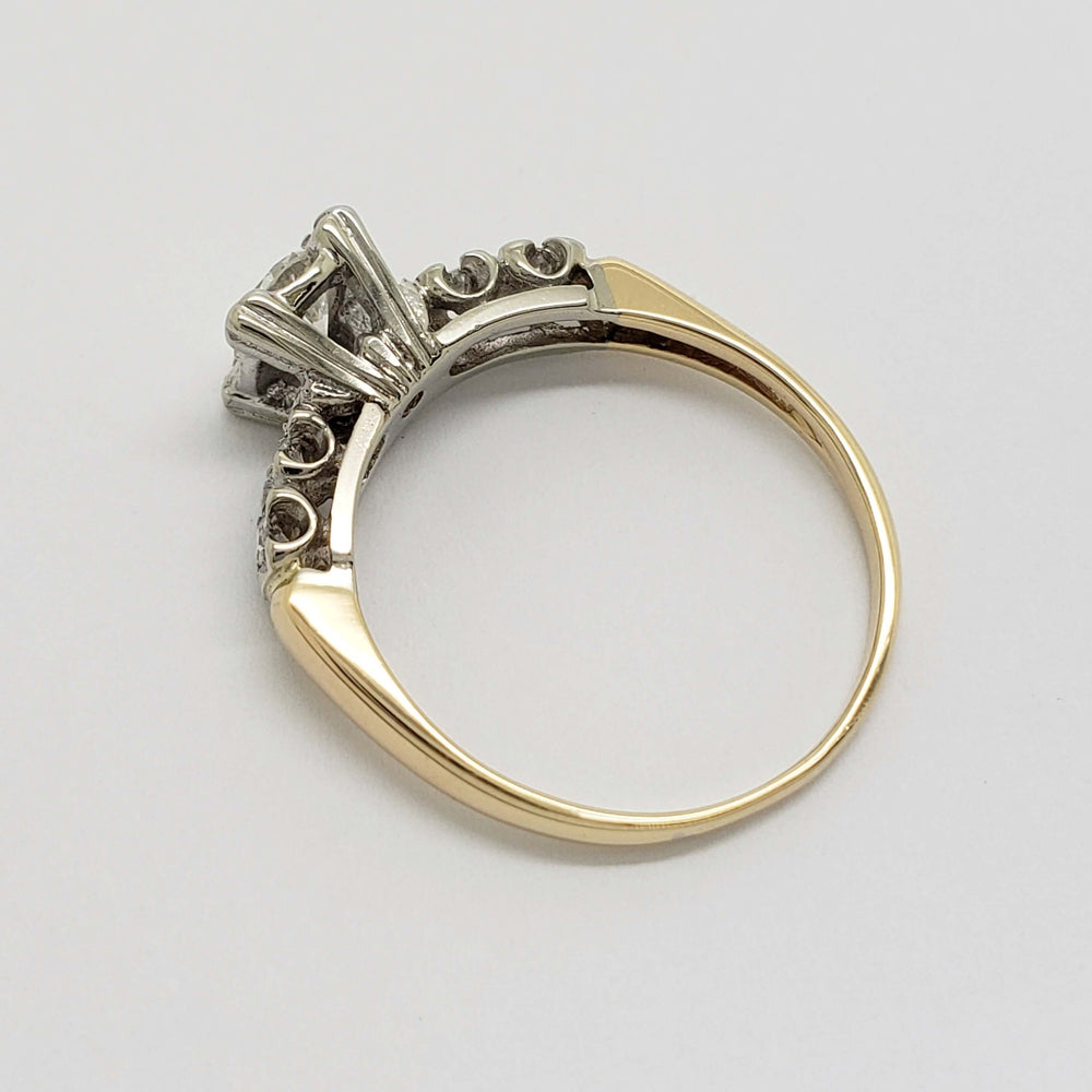 Side profile of two-tone 14kt gold antique diamond ring with illusion setting