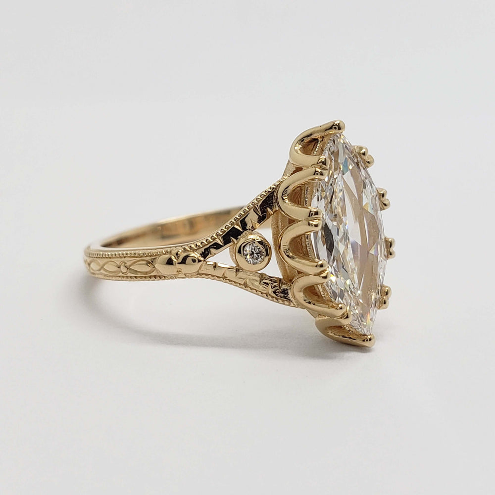 Side profile of vintage-inspired 14kt yellow gold ring with marquise lab diamond