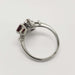 Side profile of vintage 10kt white gold cocktail ring with red glass and cubic zirconia