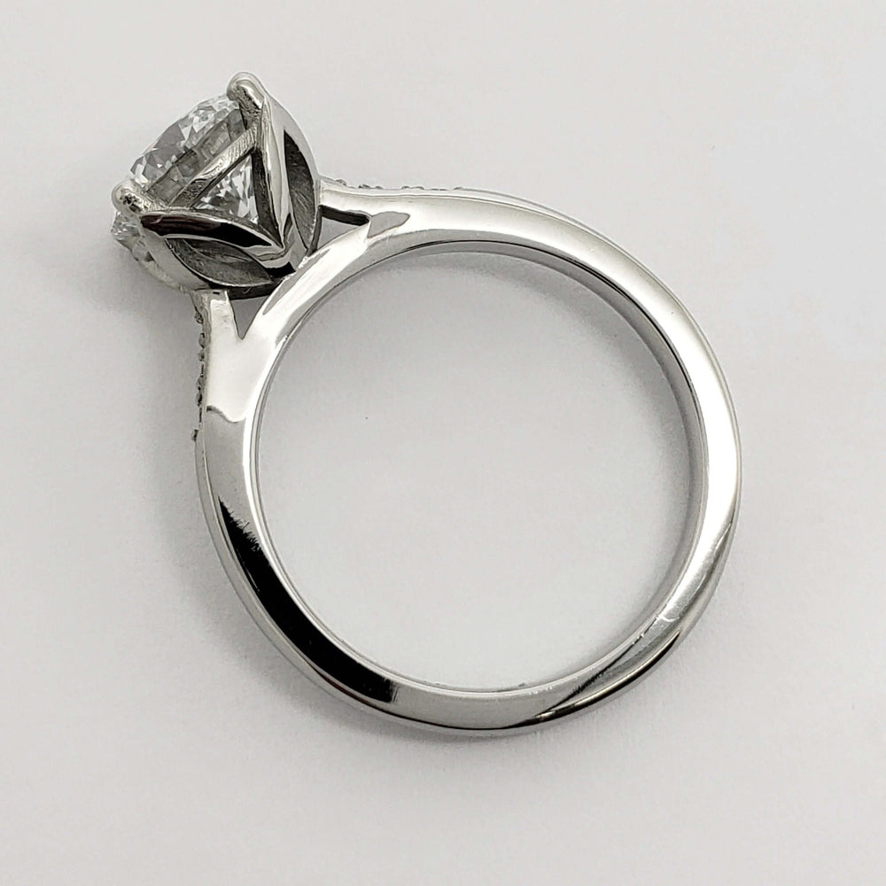 Side profile of white gold engagement ring showing tulip setting and diamond details