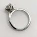 Side profile of white gold engagement ring showing tulip setting and diamond details