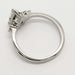 Side profile of white gold engagement ring with pear cut lab diamond and accent stones