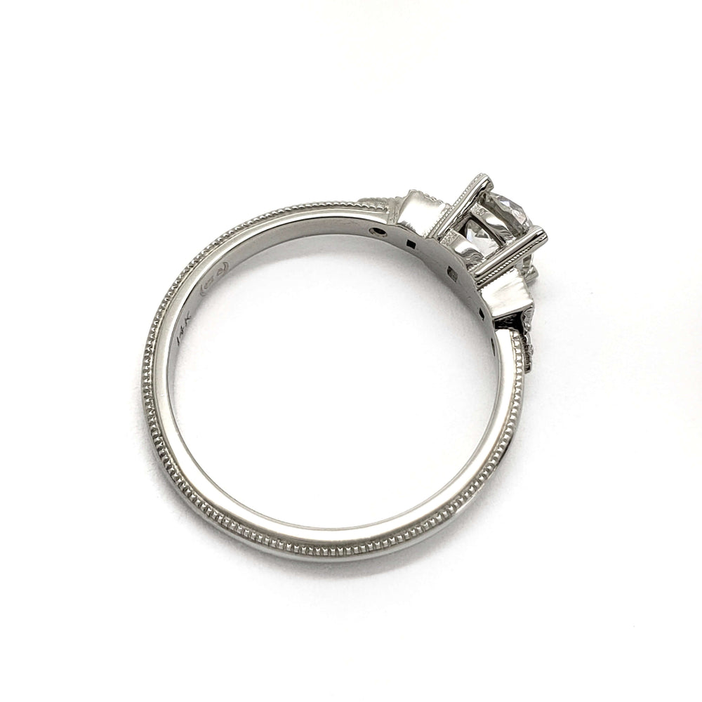 Side profile of white gold ring with antique diamond and millgrain detail