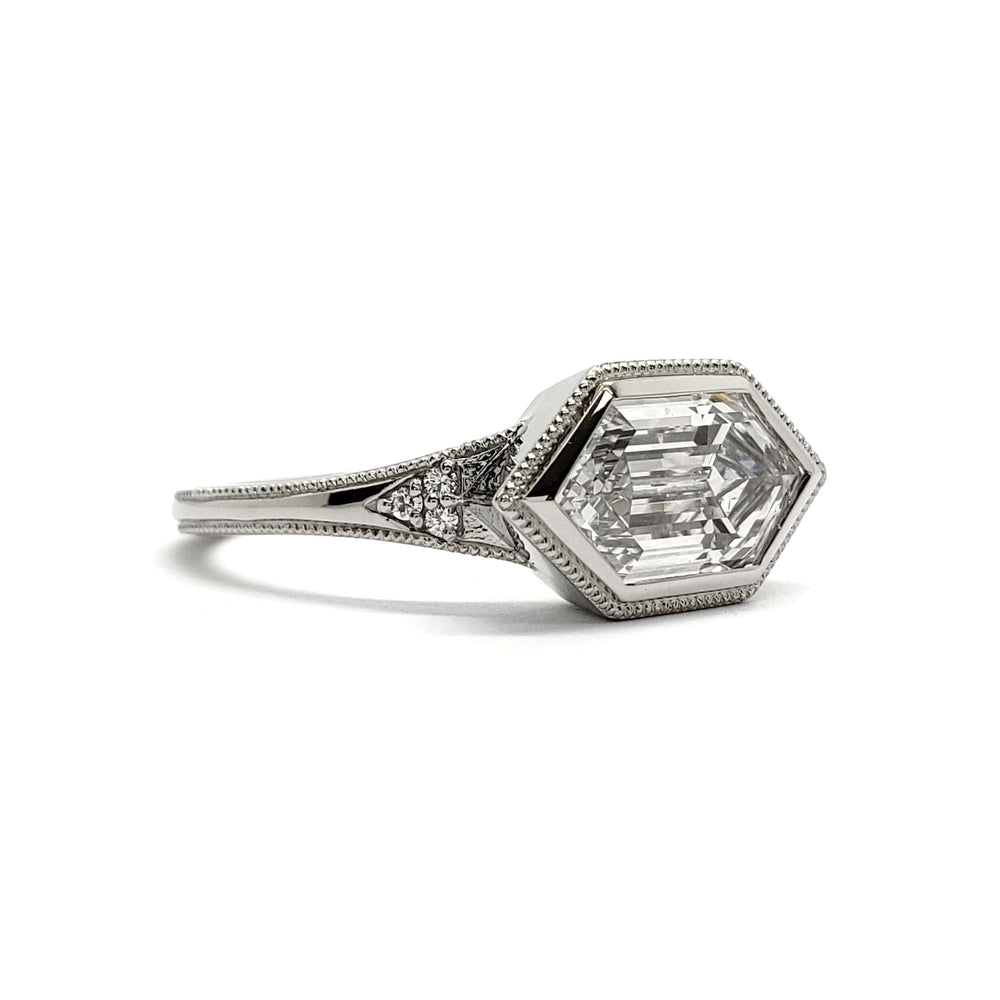 Side view of white gold engagement ring with hexagon lab diamond and pave accents
