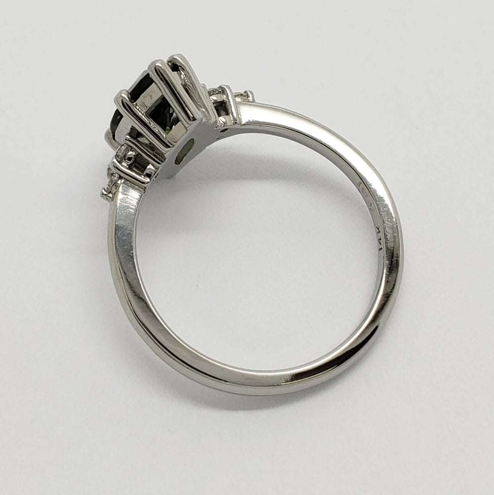 Side profile of white gold ring with marquise green sapphire and diamond accents