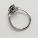 Side profile of white gold ring with marquise green sapphire and diamond accents