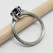 Side view of white gold ring with blue sapphire and diamond accents, millgrain edge