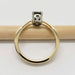 Side view of yellow and white gold ring with cushion cut green sapphire