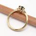 Side profile of yellow gold Montana sapphire and diamond engagement ring with millgrain detail