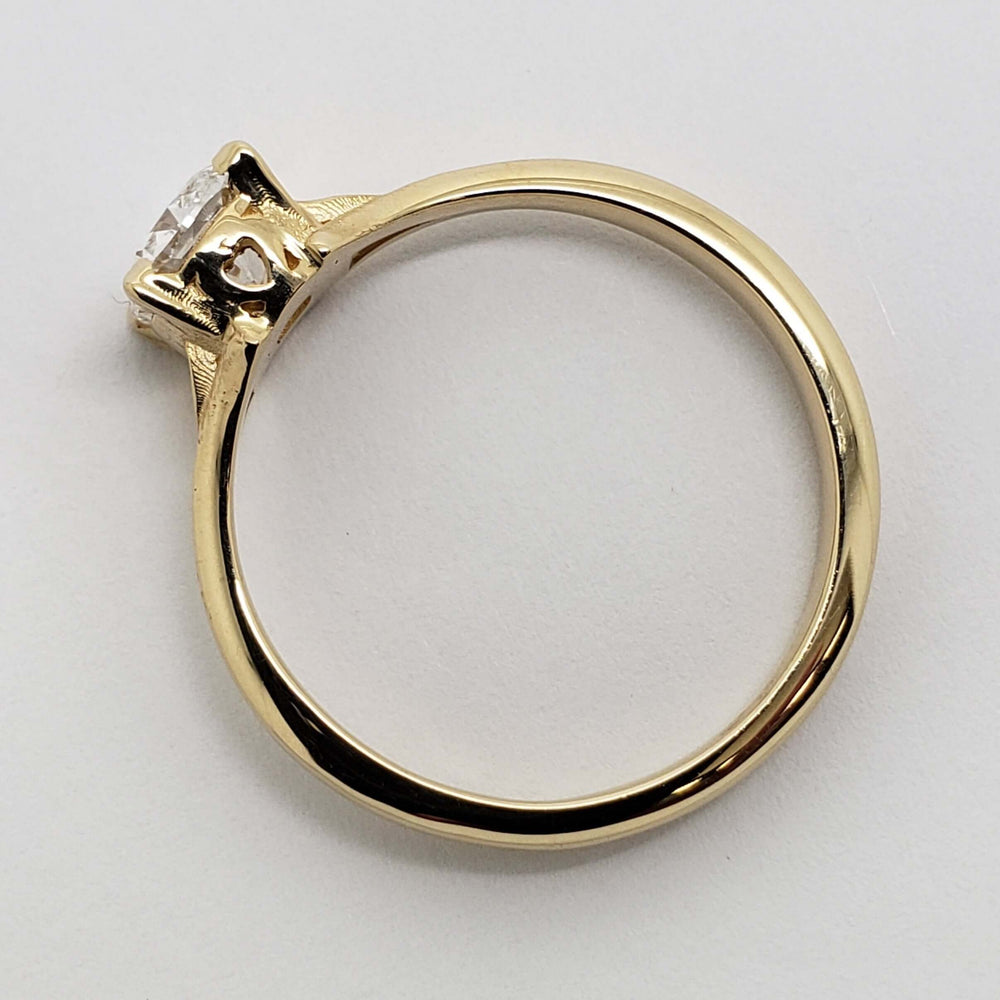Side profile of yellow gold engagement ring with cushion lab diamond