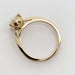 Side profile of yellow gold engagement ring showing diamond setting and polished band