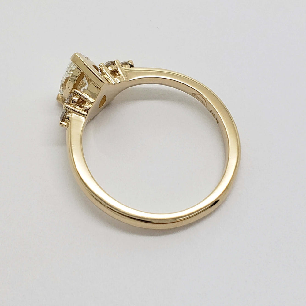 Side profile of yellow gold engagement ring with pear lab diamond setting