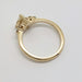 Side profile of yellow gold engagement ring with pear lab diamond setting