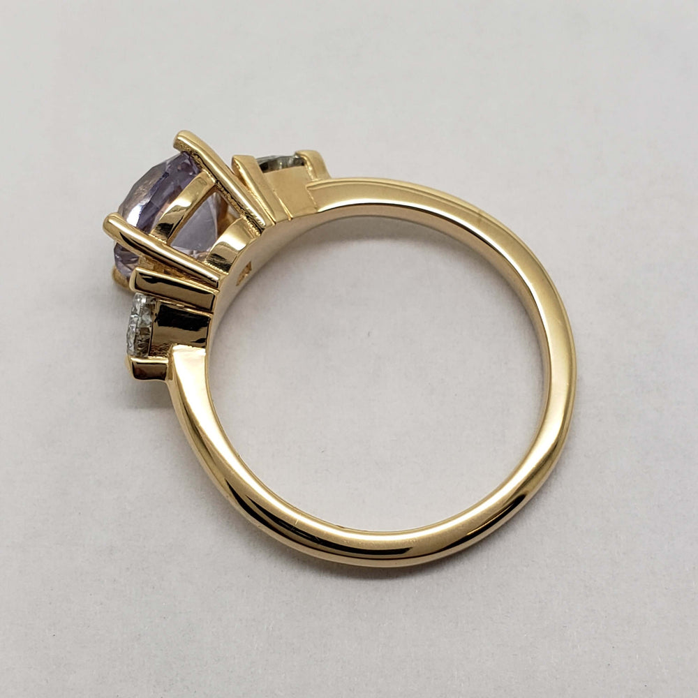 Side profile of yellow gold ring showing cushion lavender sapphire and diamond setting