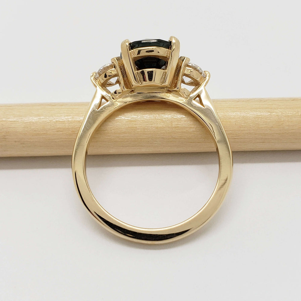 Side profile of yellow gold ring with Australian sapphire and lab diamonds on a pencil