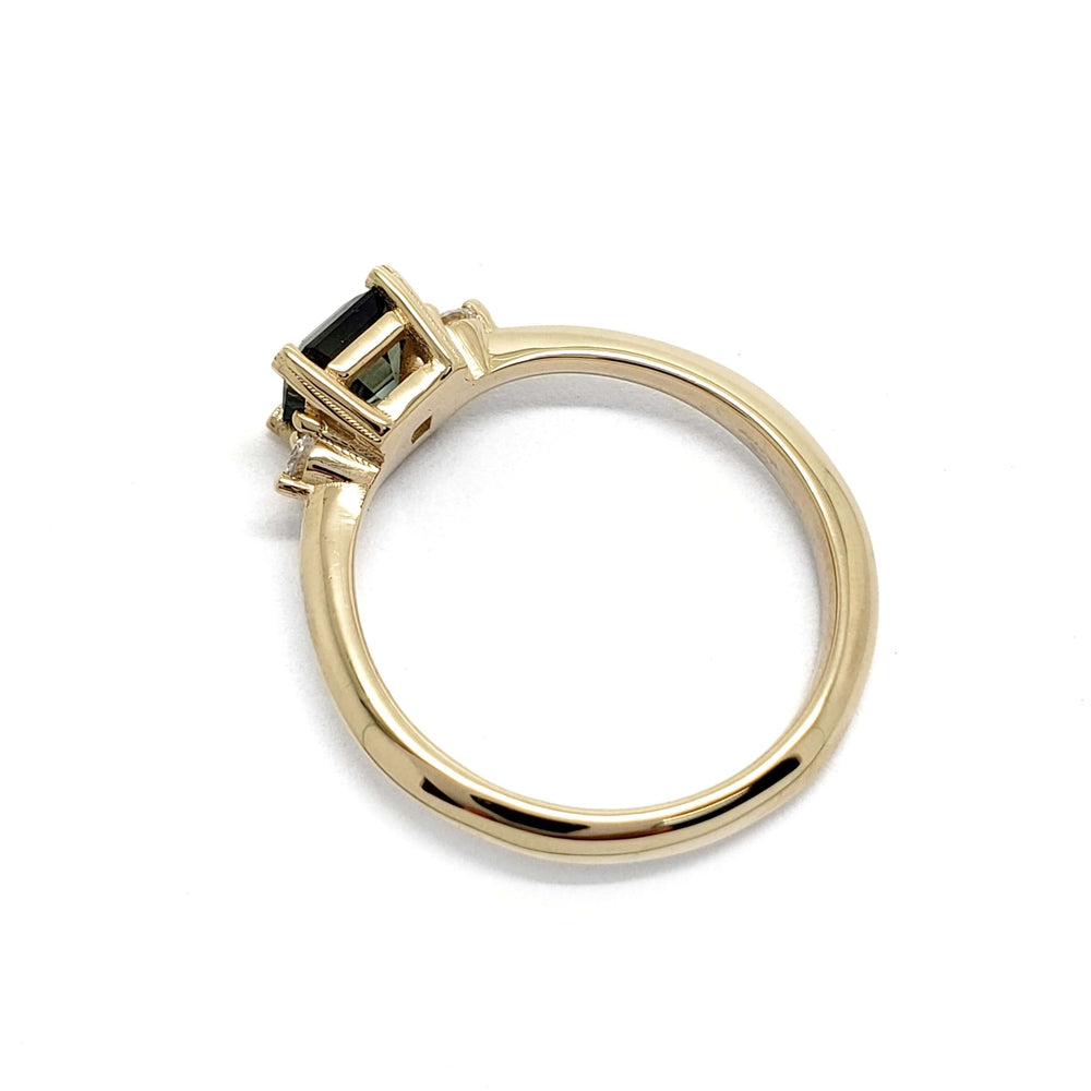 Side profile of yellow gold ring with asscher cut parti sapphire and diamond accents