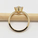 Side profile of yellow gold ring with shield cut grey sapphire, solitaire setting