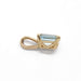 Side view of 10kt yellow gold pendant with emerald cut aquamarine, showing leaf cutouts