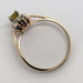Side profile of 10kt yellow gold ring showing sapphire and diamond halo setting