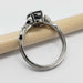 Side view of 14K white gold sapphire and diamond ring, highlighting the setting