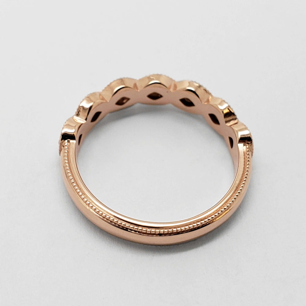 Side view of 14k rose gold wedding band with millgrain edge