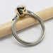 Side profile of 14k yellow and white gold ring with green Madagascar sapphire bezel setting