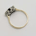Side profile of 14kt yellow and white gold three-stone ring with sapphire and diamonds
