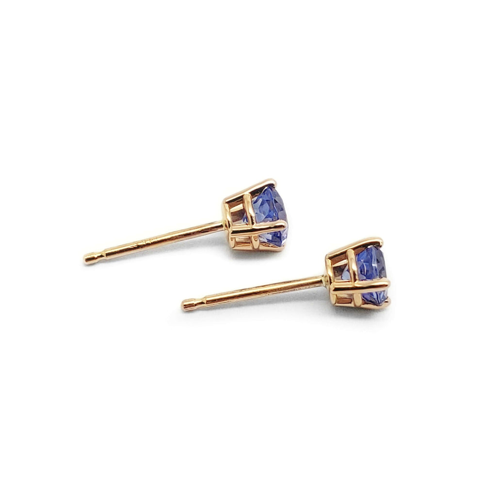 Side view of 14kt gold tanzanite stud earrings with round stones in four-claw settings