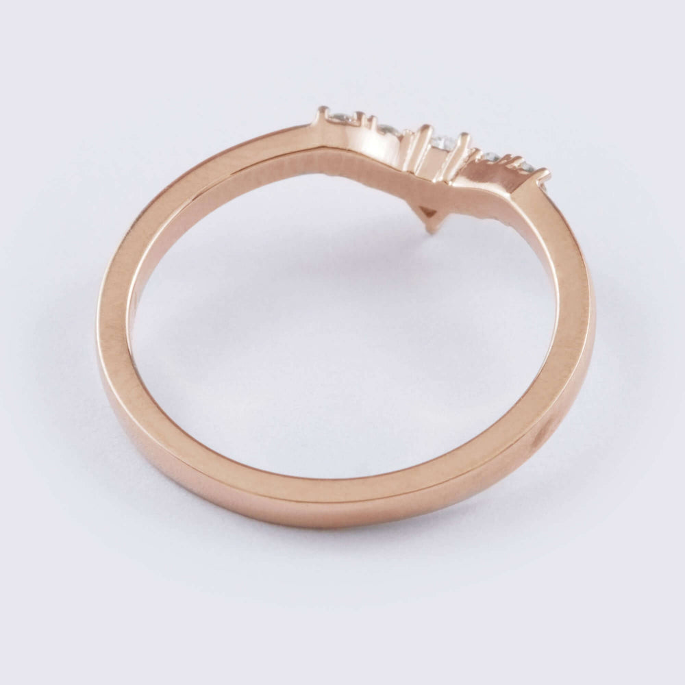 Side view of 14kt rose gold chevron diamond wedding ring band