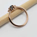 Side view of 14kt rose gold ring with blue sapphire and diamond accents
