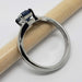 Side view of 14kt white gold Montana sapphire ring, band marked 14K, with pencil
