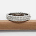 Side view of 14kt white gold leafy diamond wedding ring, resting on pencil