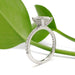 Side view of 14kt white gold oval lab diamond ring with pave band and hidden halo