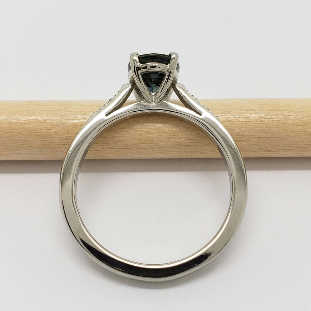 Side view of 14kt white gold ring with blue-green sapphire and pave lab diamonds