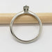 Side view of 14kt white gold ring with marquise Montana sapphire on a wooden stick