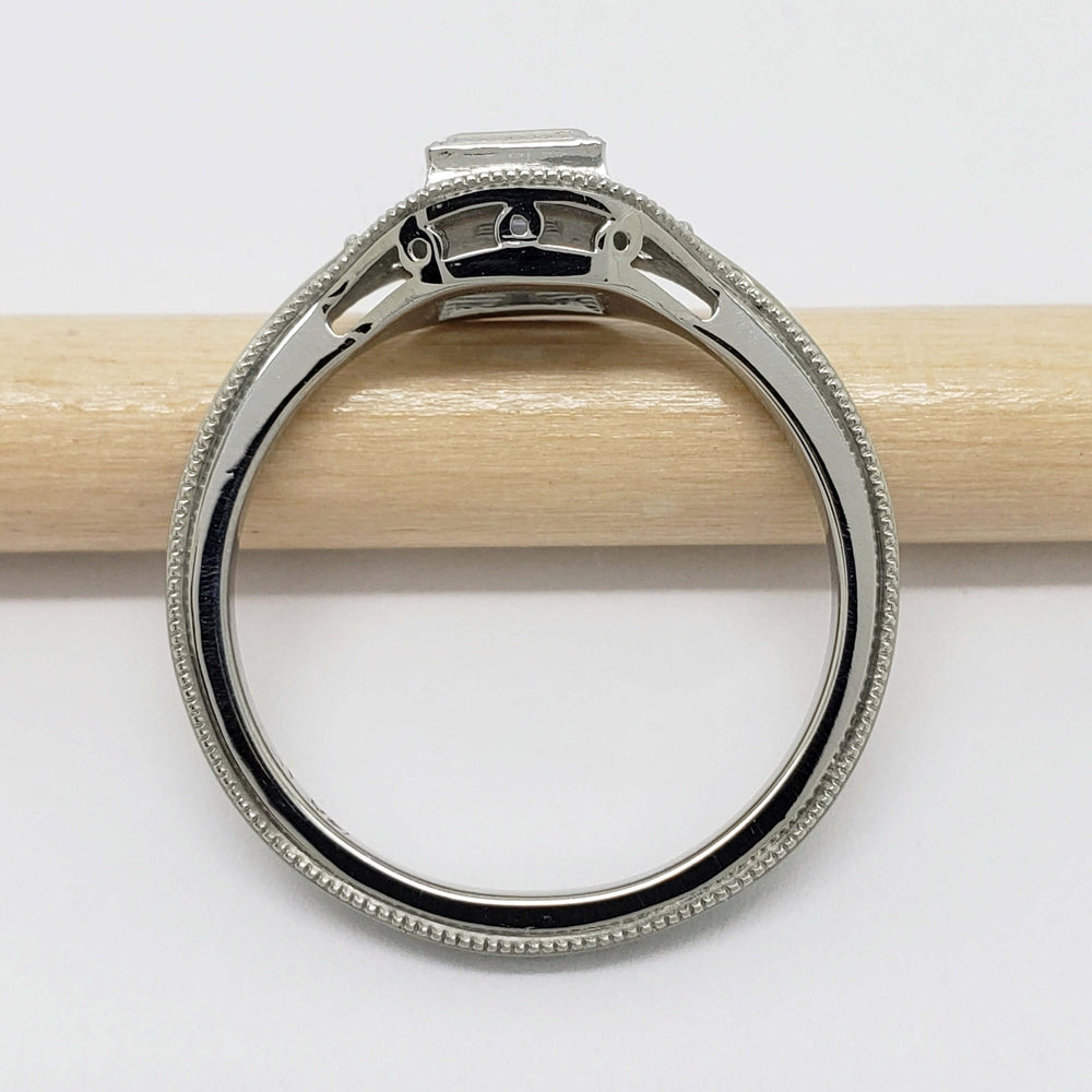 Side profile of 14kt white gold ring with millgrain edge and raised square lavender sapphire setting