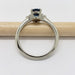 Side view of 14kt white gold ring with oval sapphire and diamond accents