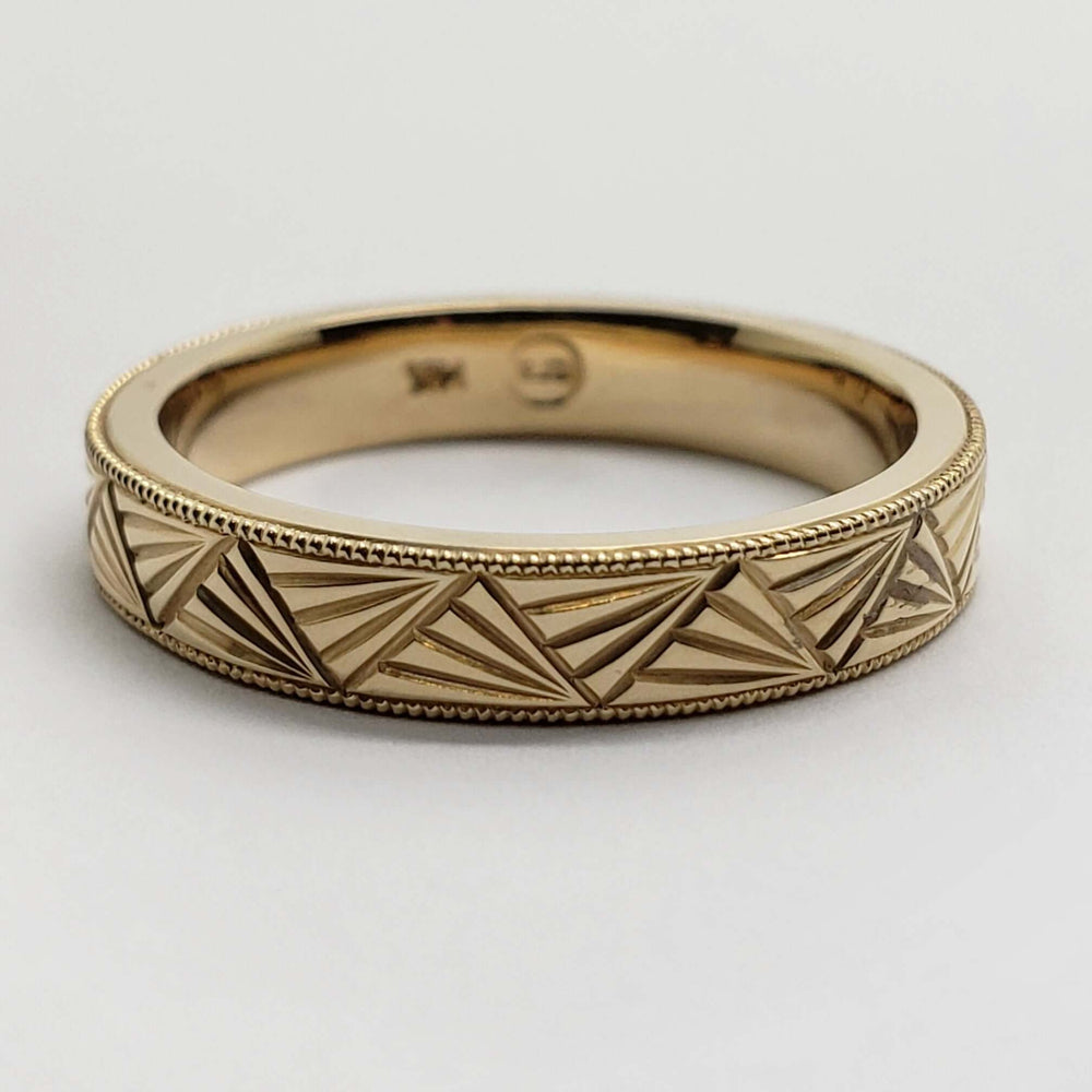 Side view of 14kt yellow gold Art Deco engraved wedding band with millgrain detail