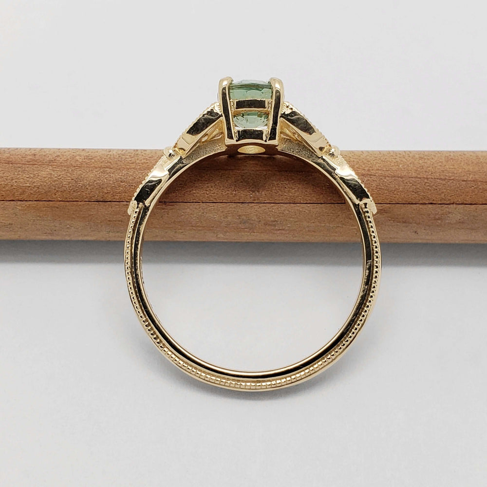 Side profile of 14kt yellow gold ring with Australian sapphire and diamond accents
