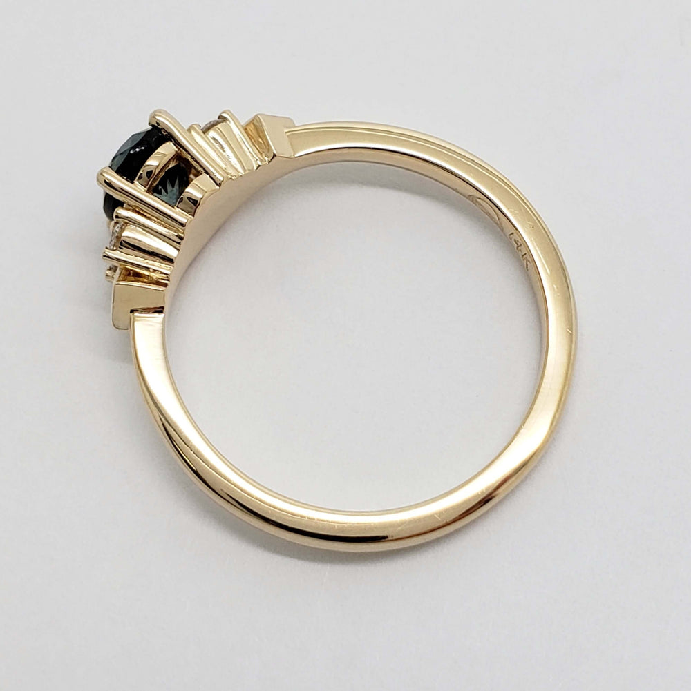 Side profile of 14kt yellow gold ring with Montana sapphire and diamond setting