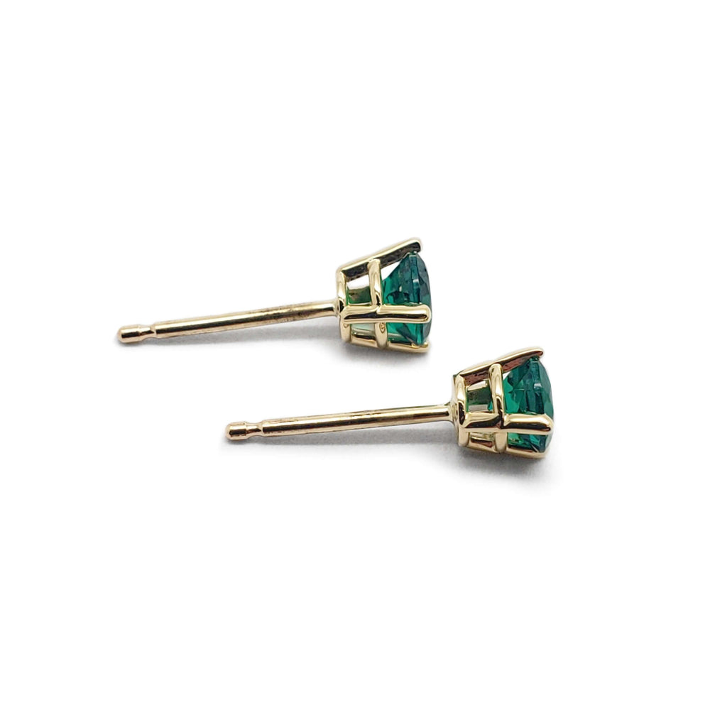 Side view of 14kt yellow gold lab emerald stud earrings showing claw setting