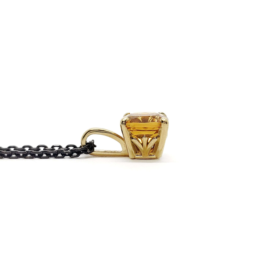 Side view of 14kt yellow gold pendant with cushion cut citrine on black chain