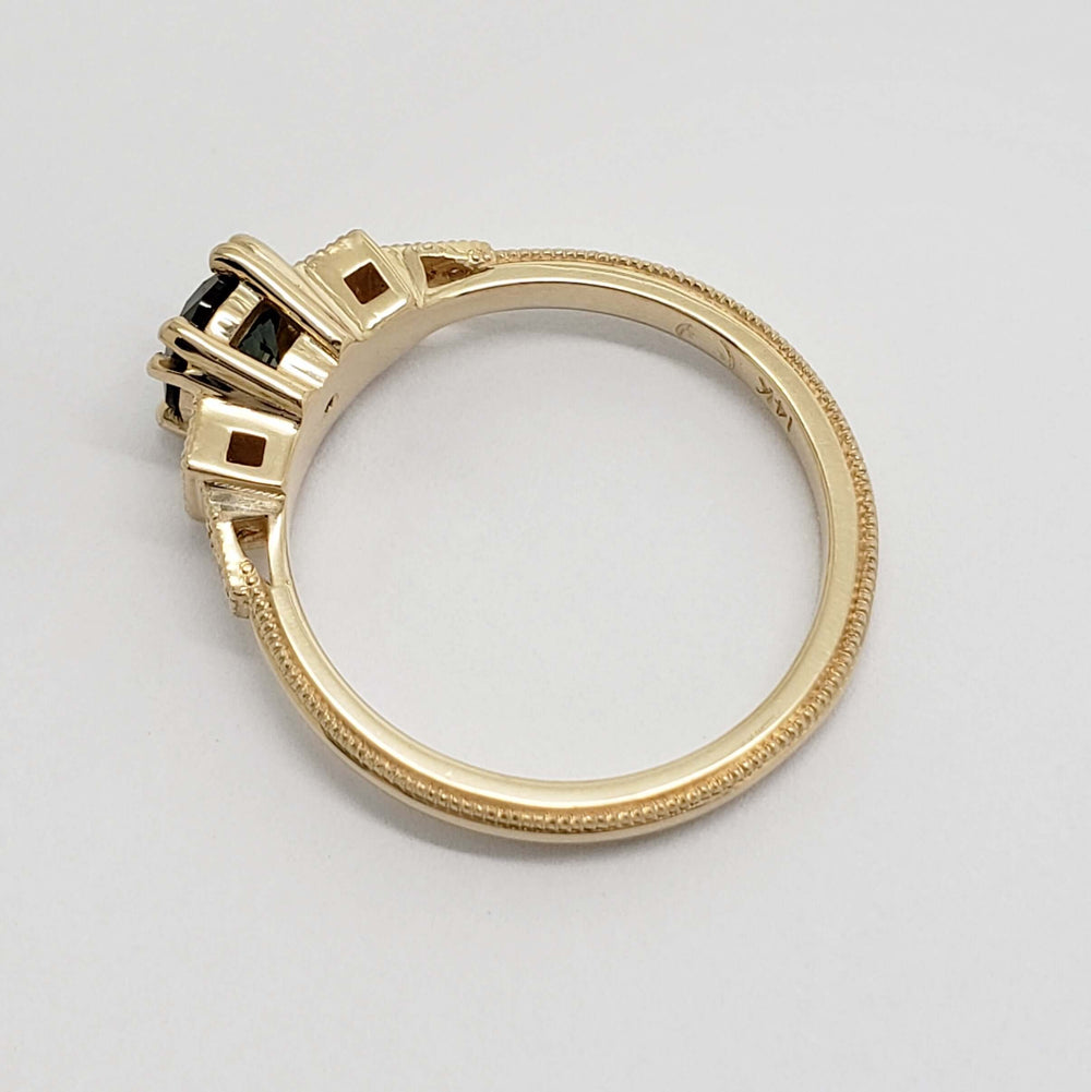 Side view of yellow gold ring showing detailed setting and milgrain edge