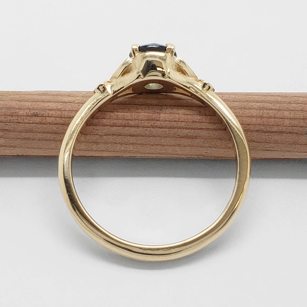 Side view of 14kt yellow gold ring with teal Montana sapphire and diamond accents