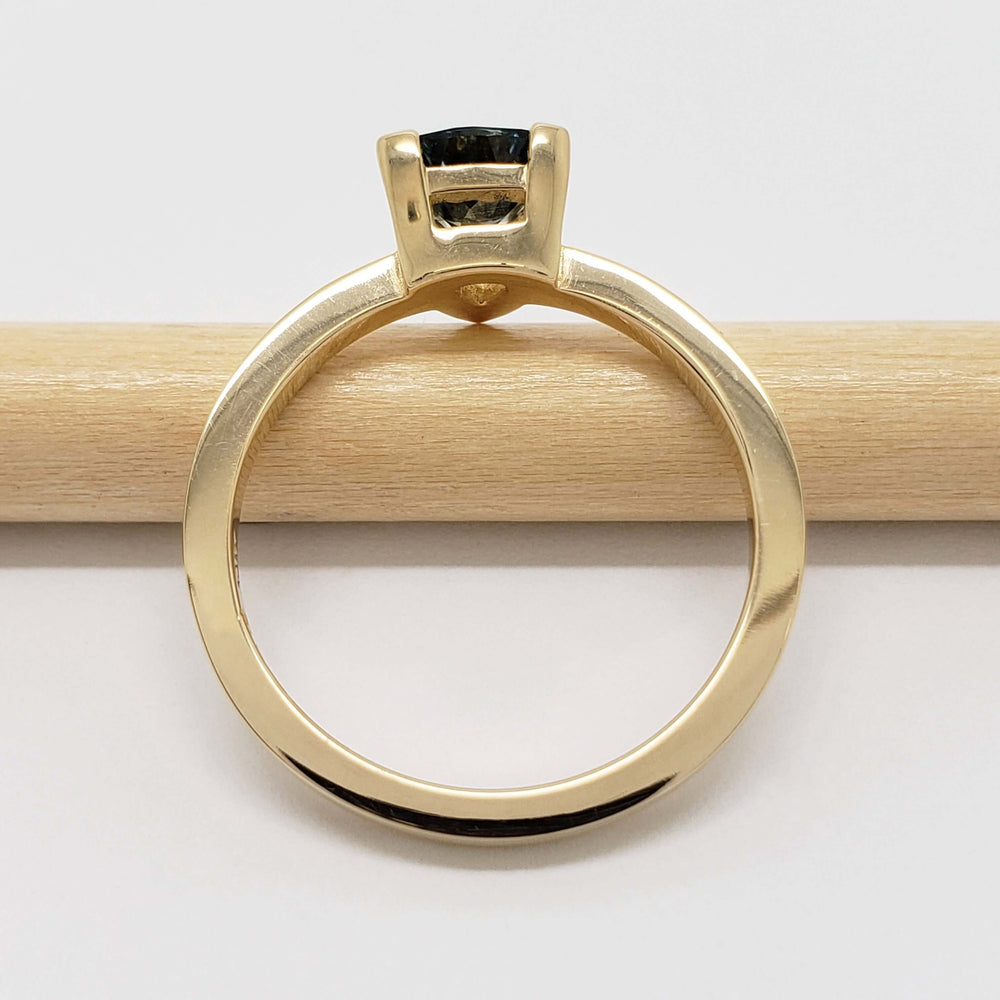 Side profile of 14kt yellow gold ring with trillion teal Australian sapphire
