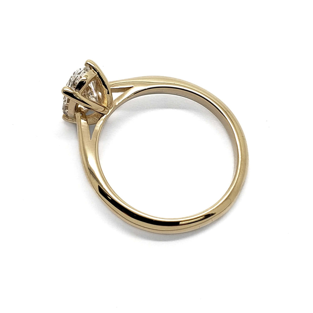 Side profile of 14kt yellow gold solitaire ring with oval lab diamond