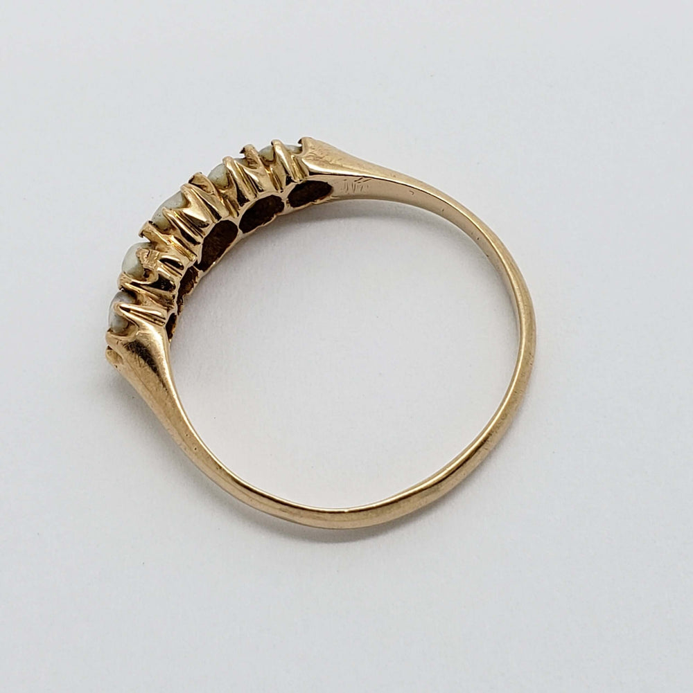Side view of 15kt yellow gold ring with five seed pearls in prong setting